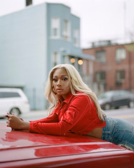 Megan posing near a car